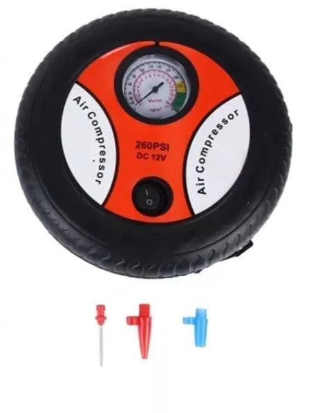 Air compressor with gauge and attachments on a white background